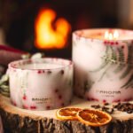 Lit up Spirit of Christmas - Grand Botanical Pillar together with the small Spirit of Christmas Botanical pillar Candle lifestyle