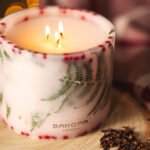 Lit up Spirit of Christmas - Grand Botanical Pillar Candle lifestyle from an angle