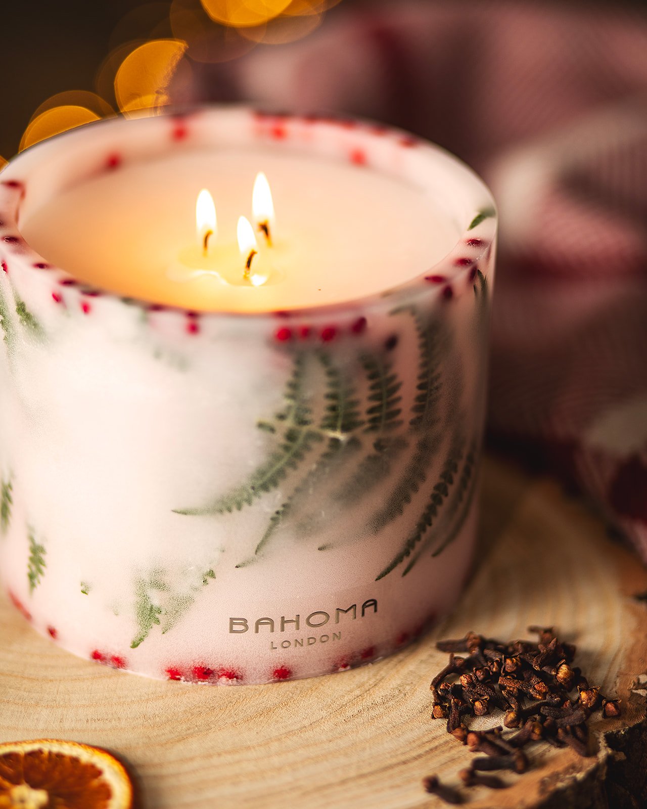 Lit up Spirit of Christmas - Grand Botanical Pillar Candle lifestyle from an angle