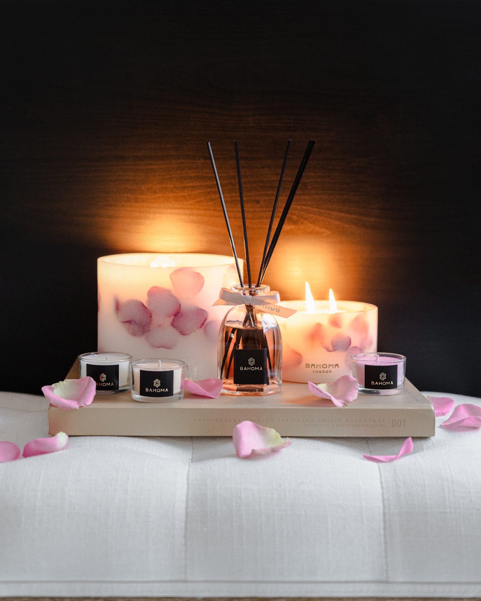 Velvet Rose - 200ml Fragranced Octagonal Diffuser with botanical candles and mini travel candles on a tray on a bed side
