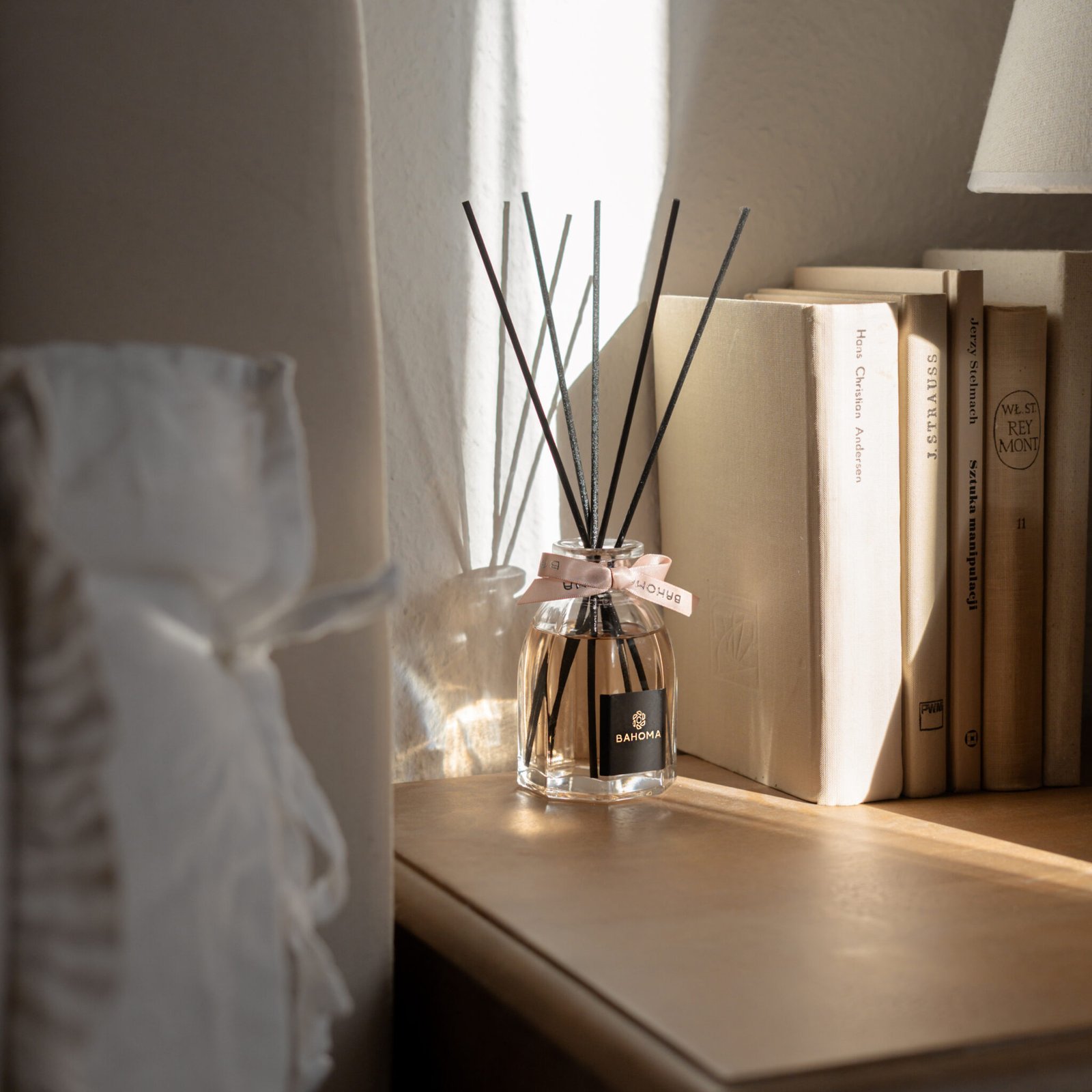 Velvet Rose -100ml Fragranced Octagonal Diffuser with a pink ribbon, on a window seal in sunshine