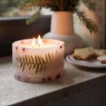 Spirit of Christmas - Small Botanical Pillar Candle lit on a window